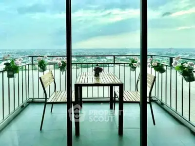Stunning balcony with panoramic city view and elegant outdoor seating.