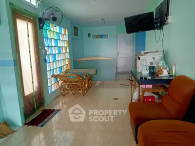 Cozy living room with colorful glass block wall and modern amenities.
