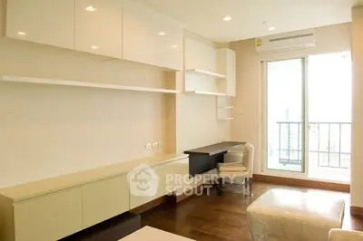 Modern living room with sleek built-in shelves and balcony access in a bright apartment.
