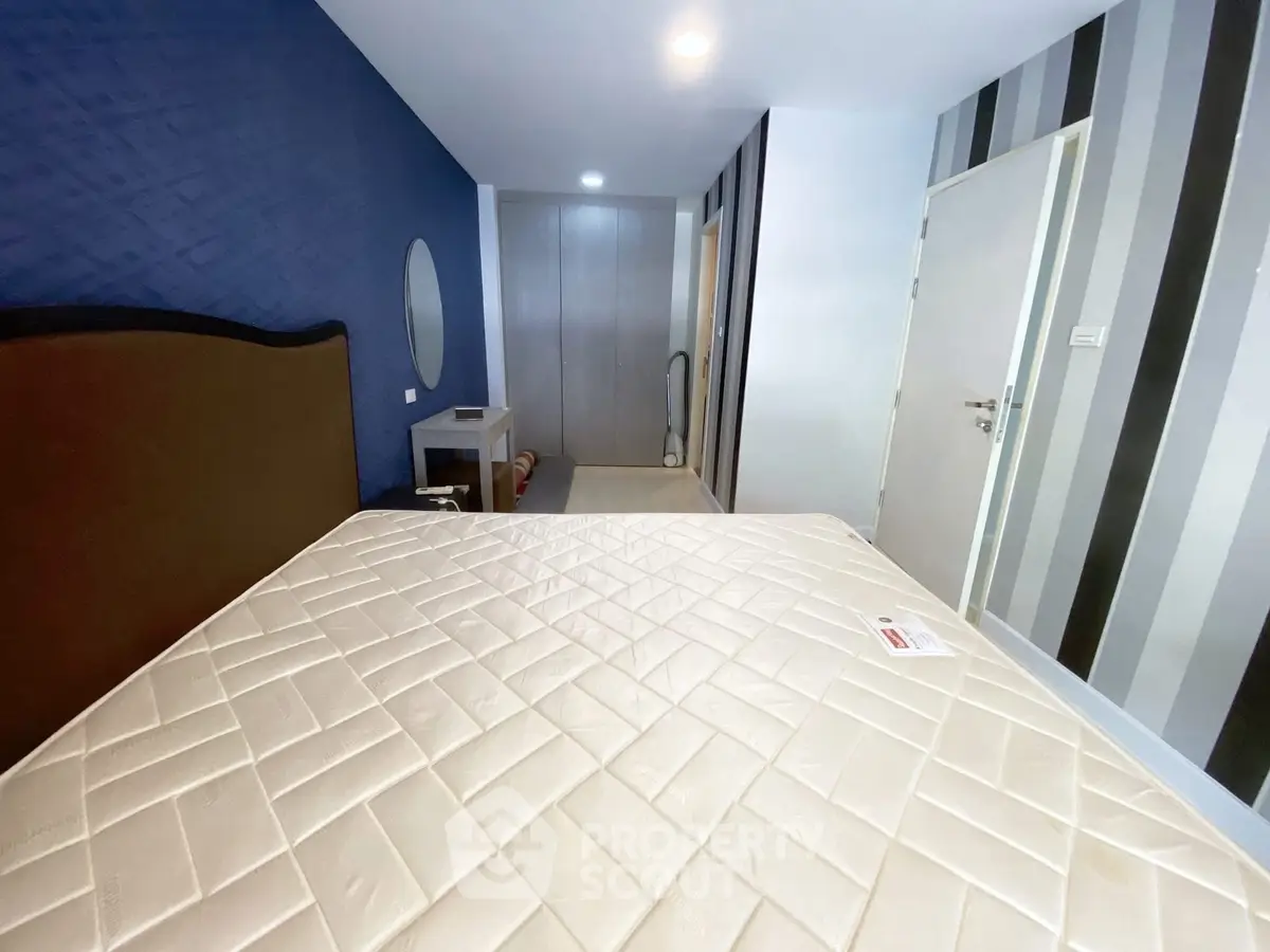 Spacious bedroom with modern decor and ample natural light