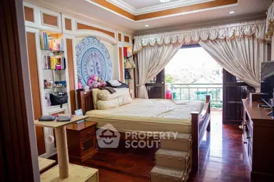 Charming bedroom with elegant decor and balcony view, perfect for relaxation.