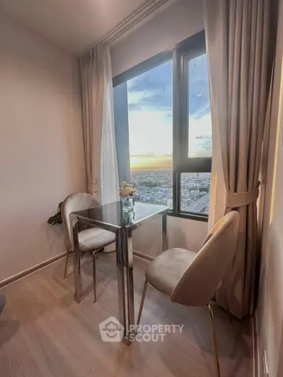 Chic dining nook with stunning city view, featuring elegant chairs and a sleek glass table.