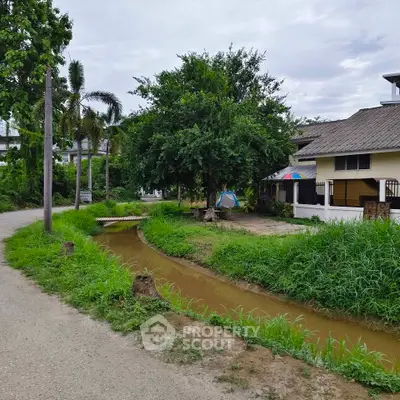Charming rural property with lush greenery and a serene canal view, perfect for nature lovers seeking tranquility.