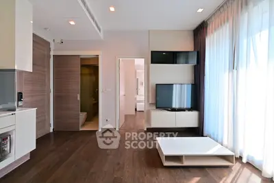 Modern living room with sleek wooden flooring and large windows