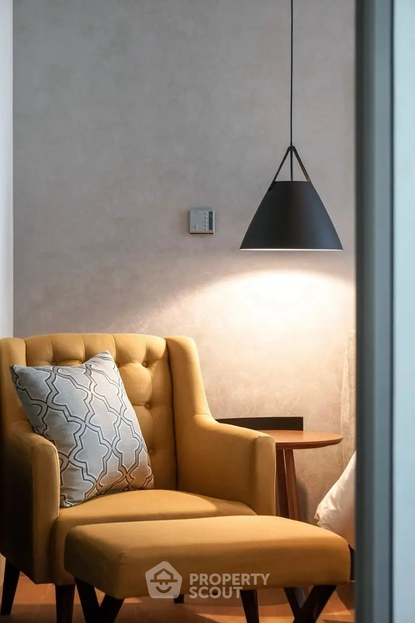 Cozy reading nook with stylish armchair and modern pendant light