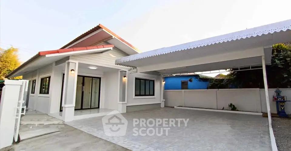 Charming single-story home with spacious driveway and modern exterior design.