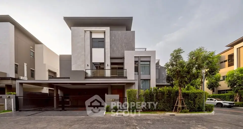 Modern luxury house exterior with sleek design and spacious driveway in upscale neighborhood.
