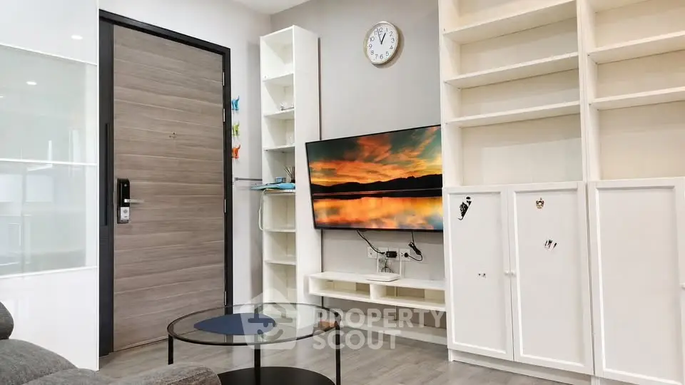 Modern living room with wall-mounted TV and stylish shelving