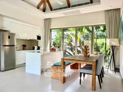 Modern kitchen with open layout and dining area, featuring large windows and lush garden view.