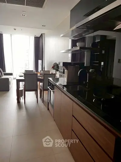 Modern open-layout kitchen and living room with sleek design and natural light