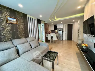 Modern living room with stylish decor and open kitchen layout in a contemporary apartment.