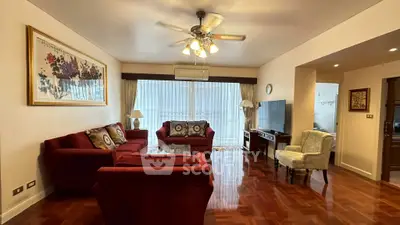 Spacious living room with elegant decor and large windows in a modern apartment.