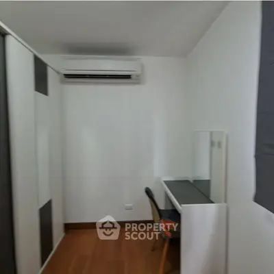 Modern study room with sleek desk and air conditioning in a minimalist design.