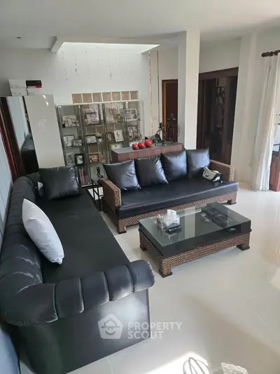 Spacious living room with modern furniture and glass coffee table