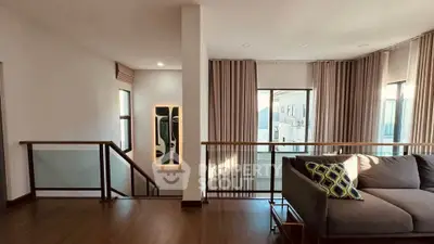 Stylish living room with modern decor and large windows offering ample natural light.