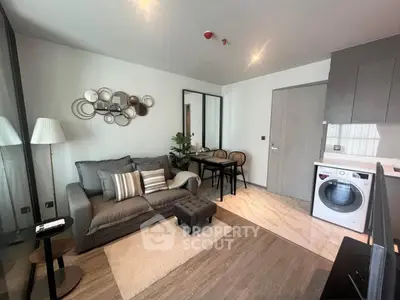 Modern living room with stylish decor and in-unit washing machine, perfect for urban living.