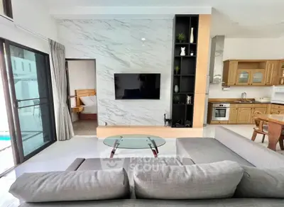 Modern living room with open kitchen and stylish decor