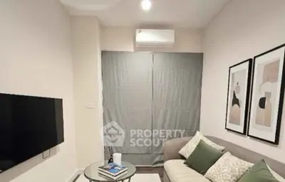 Cozy living room with modern decor and wall-mounted TV, perfect for relaxation.