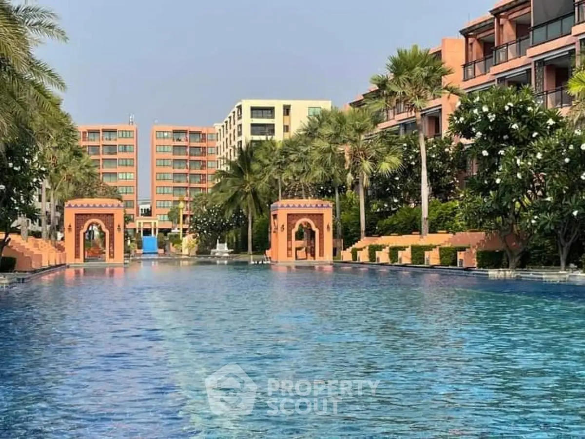 Luxurious resort-style pool with palm trees and elegant architecture