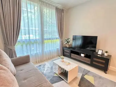 Modern living room with large window, stylish furniture, and natural light.
