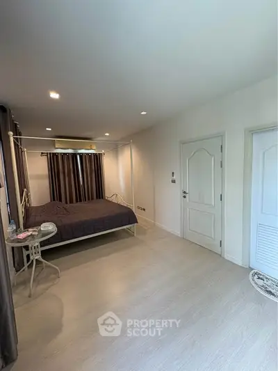 Spacious bedroom with modern decor and natural light