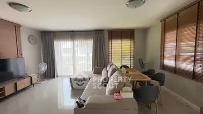 Spacious living room with modern furniture and large windows for natural light.