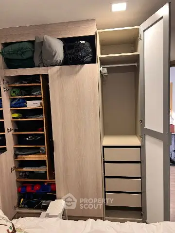 Spacious bedroom with modern built-in wardrobe and ample storage space.