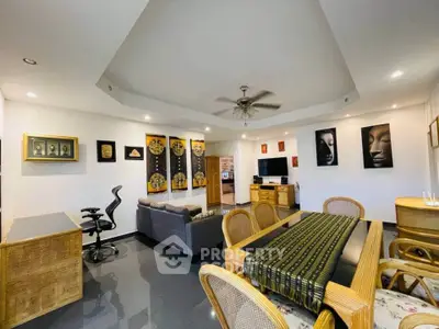 Spacious living room with modern decor and elegant dining area