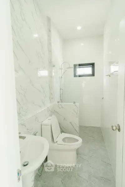 Modern bathroom with marble tiles and sleek fixtures