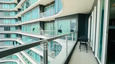 Modern apartment balcony with glass railings and city view
