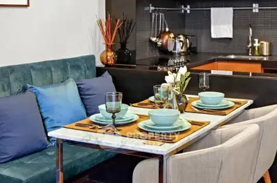 Stylish modern kitchen with elegant dining setup and cozy seating area.