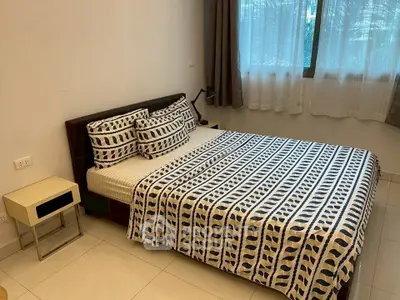 Cozy bedroom with modern decor and ample natural light