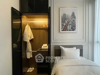 Elegant bedroom with sleek wardrobe and cityscape artwork, perfect for modern living.