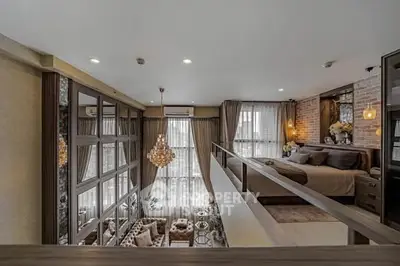Luxurious loft-style bedroom with elegant decor and large windows