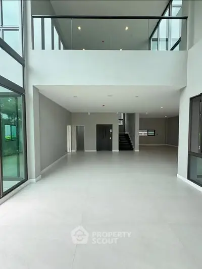 Spacious modern living room with high ceilings and large windows