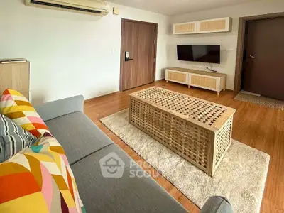 Stylish living room with modern furniture and wooden flooring, perfect for cozy gatherings.