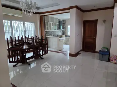 Spacious dining area with elegant chandelier and open kitchen layout