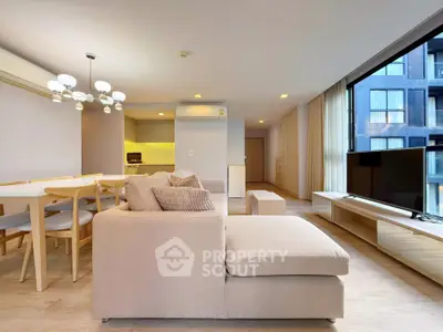 Spacious modern living room with open kitchen and large windows in luxury apartment