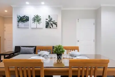Modern dining area with wooden table and stylish decor in a cozy living space.