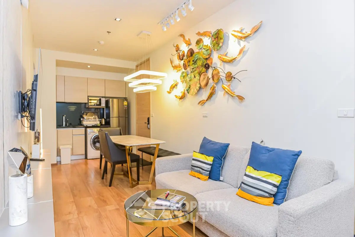 Modern living room with stylish decor and open kitchen layout in a cozy apartment.
