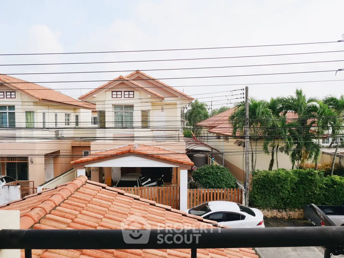 Charming suburban neighborhood with tiled roofs and lush greenery, showcasing a peaceful residential area.