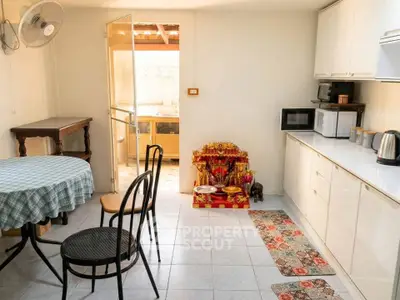 Charming kitchen with dining area and traditional decor, featuring modern appliances and ample natural light.