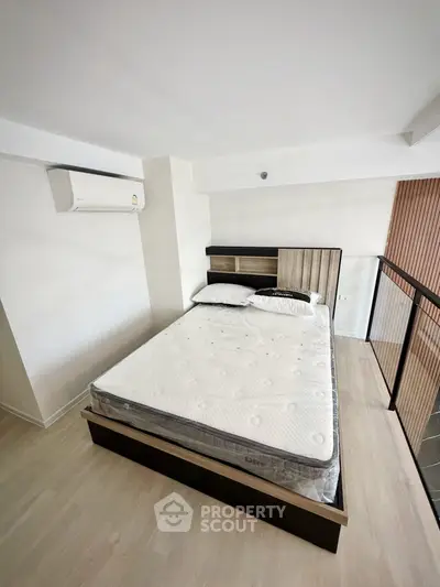 Modern bedroom with stylish bed and air conditioning in a bright, minimalist design.