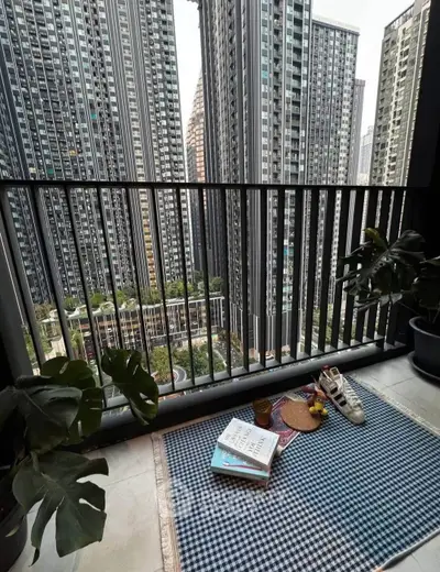 Chic urban balcony with stunning cityscape view and cozy decor