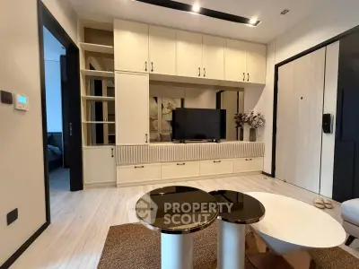 Modern living room with sleek cabinetry and stylish decor in a contemporary apartment.