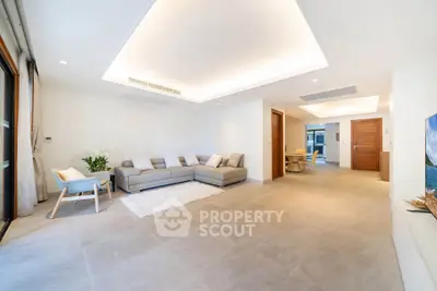 Spacious modern living room with elegant decor and ample natural light.