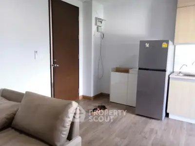 Modern apartment interior with sleek kitchen and cozy living area.