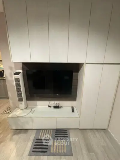 Modern living room with sleek built-in entertainment center and stylish flooring