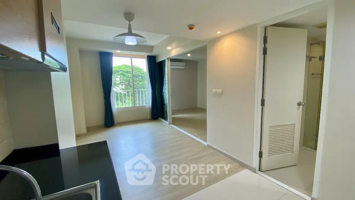 Modern apartment interior with open layout and large window view