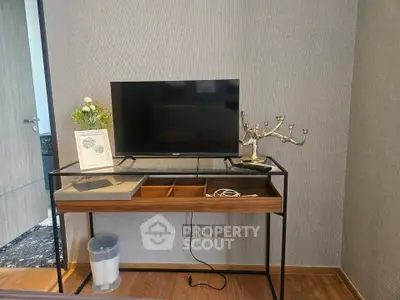 Modern interior with sleek TV stand and decorative elements in stylish living space.